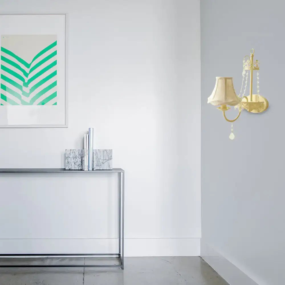 Modern beige ornate crystal sconce with gold-toned wall fixture cream lampshade and dangling beads 15 inch fixture