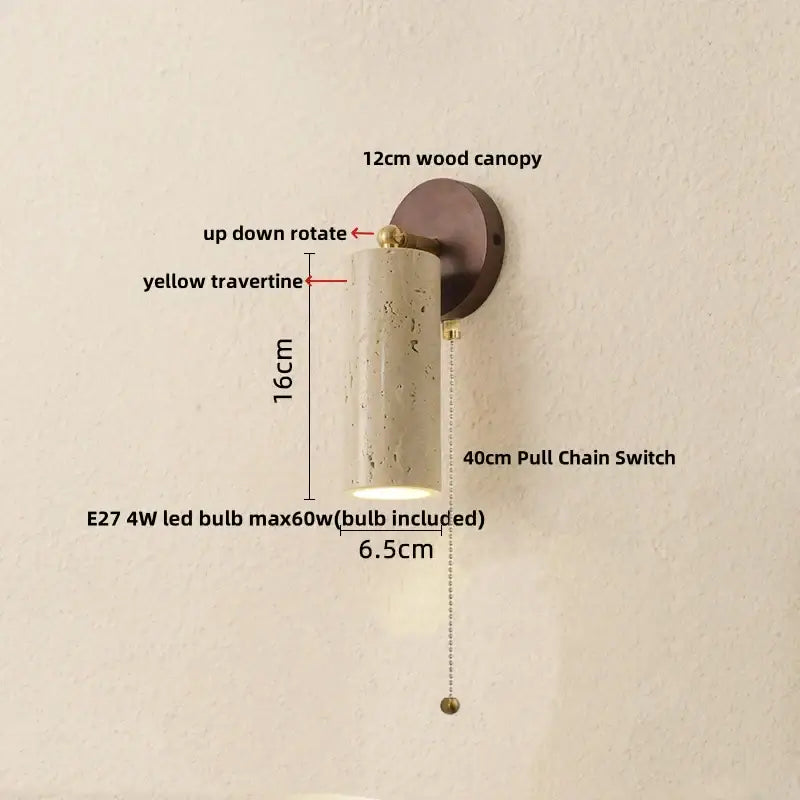 Modern beige stone and bronze wall light fixture with a yellow travertine cylindrical sconce and brass accents