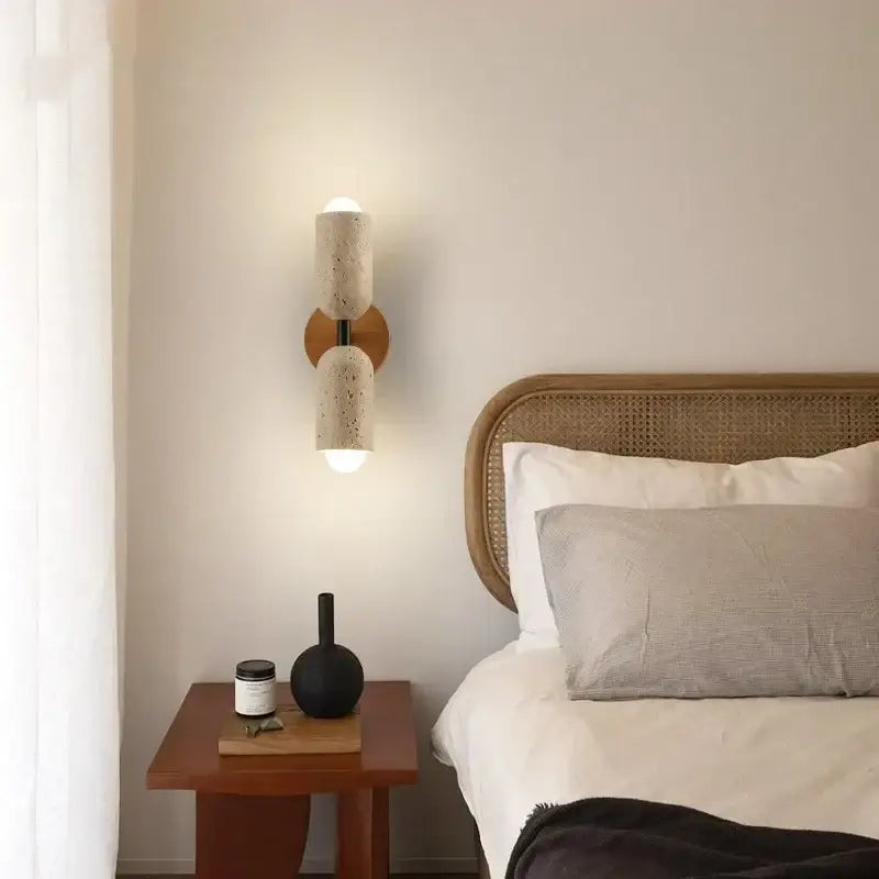 Modern beige terrazzo wall light fixture with cylindrical design and wooden circular base for bedroom use