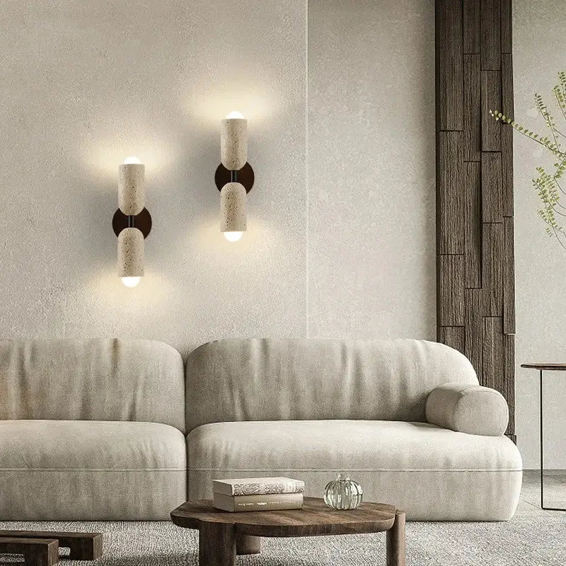 Modern beige stone and wood wall light fixture with sleek minimalist design and warm ambient lighting for bedroom sconce