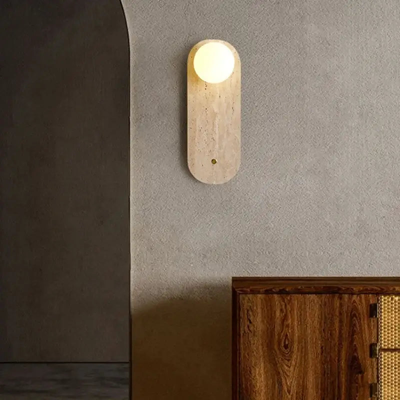Modern beige stone led wall light with a warm oval textured finish featuring a glowing decorbites led wall light fixture