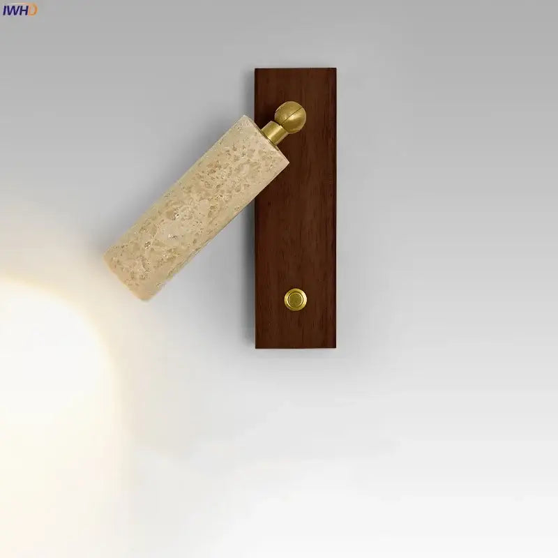 Modern beige travertine copper led wall lamp with textured stone cylinder and brass accents on dark wood base decorbites copper led