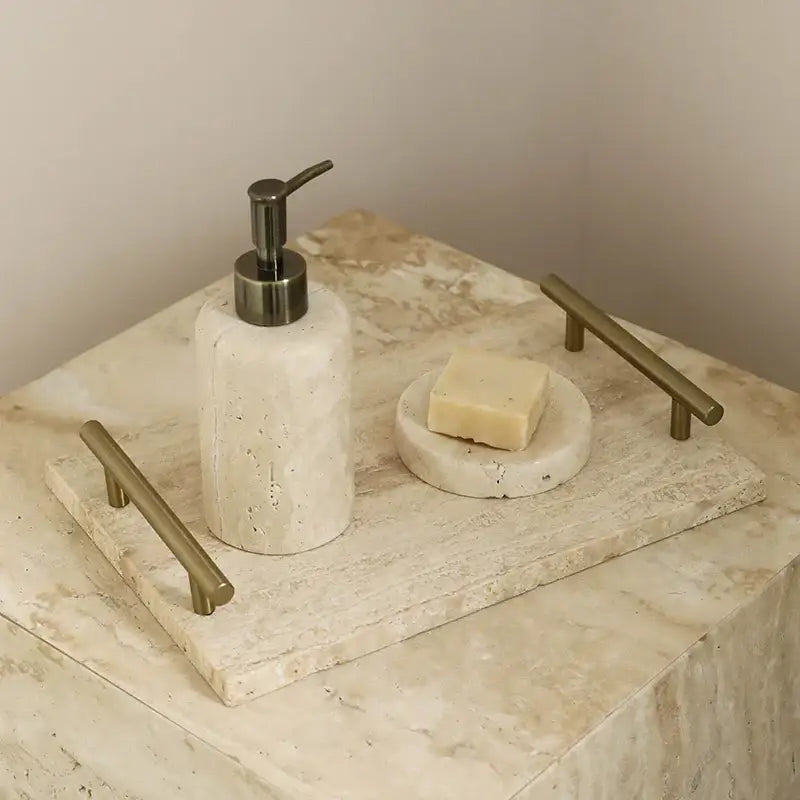 Modern beige travertine stone tray with two gold handles and matching soap dish holding a bar of soap decorbites beige travertine