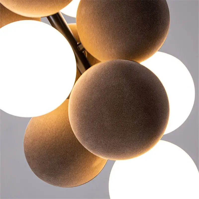 Modern beige and white decorbites abstracta pendant lamp featuring matte brown velvet shades and warm glowing bulbs