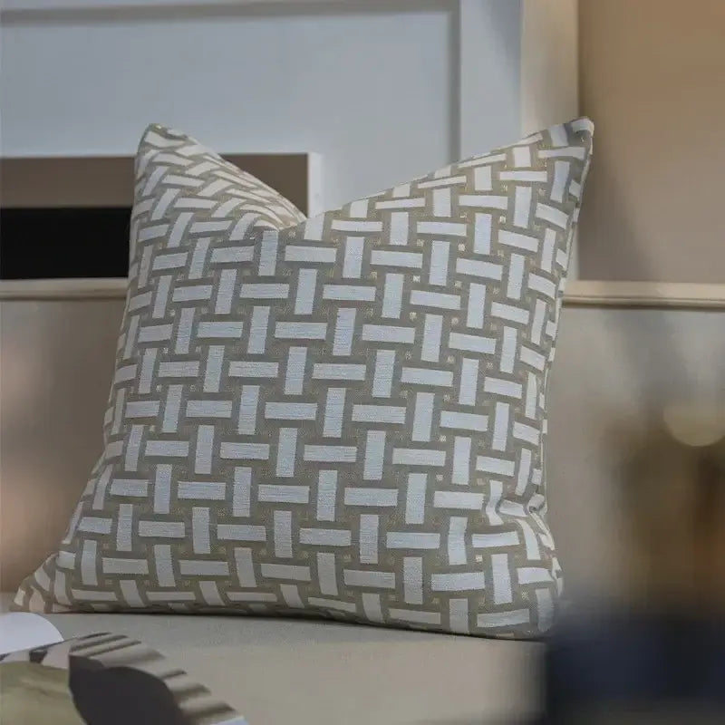 A modern beige and white jacquard cushion cover with woven geometric pattern and textured fabric finish for living room decor