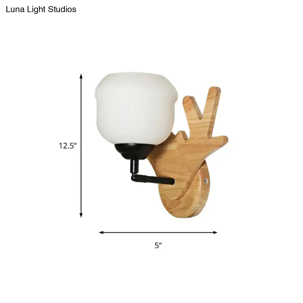 Modern beige wood deer head wall light with frosted white glass shade and black metal accents for bedroom use