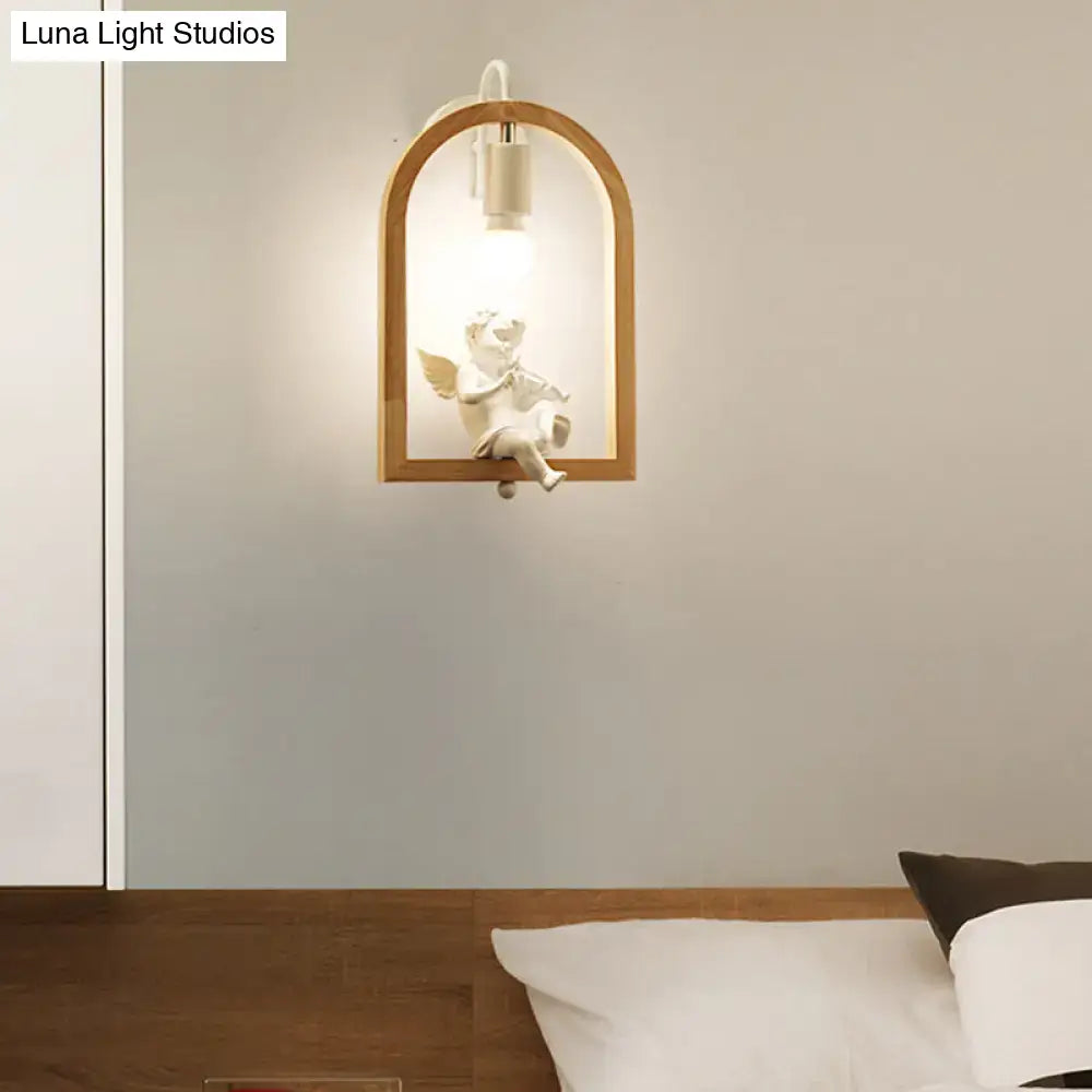 Modern beige wooden arched wall lamp with white ceramic cherub and integrated power source measures nine inches