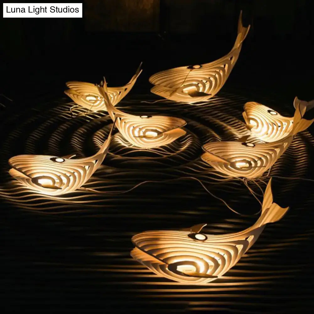 Modern beige wooden whale kids pendant light with warmly glowing layered design for bedroom hanging lamp