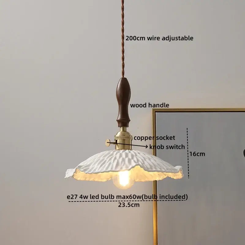 Modern bell ceramic led pendant light featuring a white fluted ceramic shade with dark wood handle and brass accents decorbites ceramic led