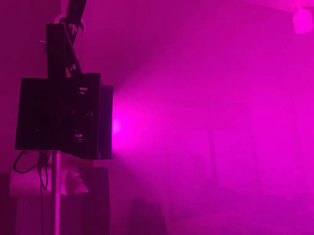 Modern black 200w cob led par blinder emitting a bright purple beam for disco dj stage lighting