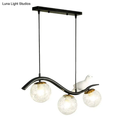 DecorBites modern black metal pendant lamp with three clear white textured ball shades and a white ceramic bird decor