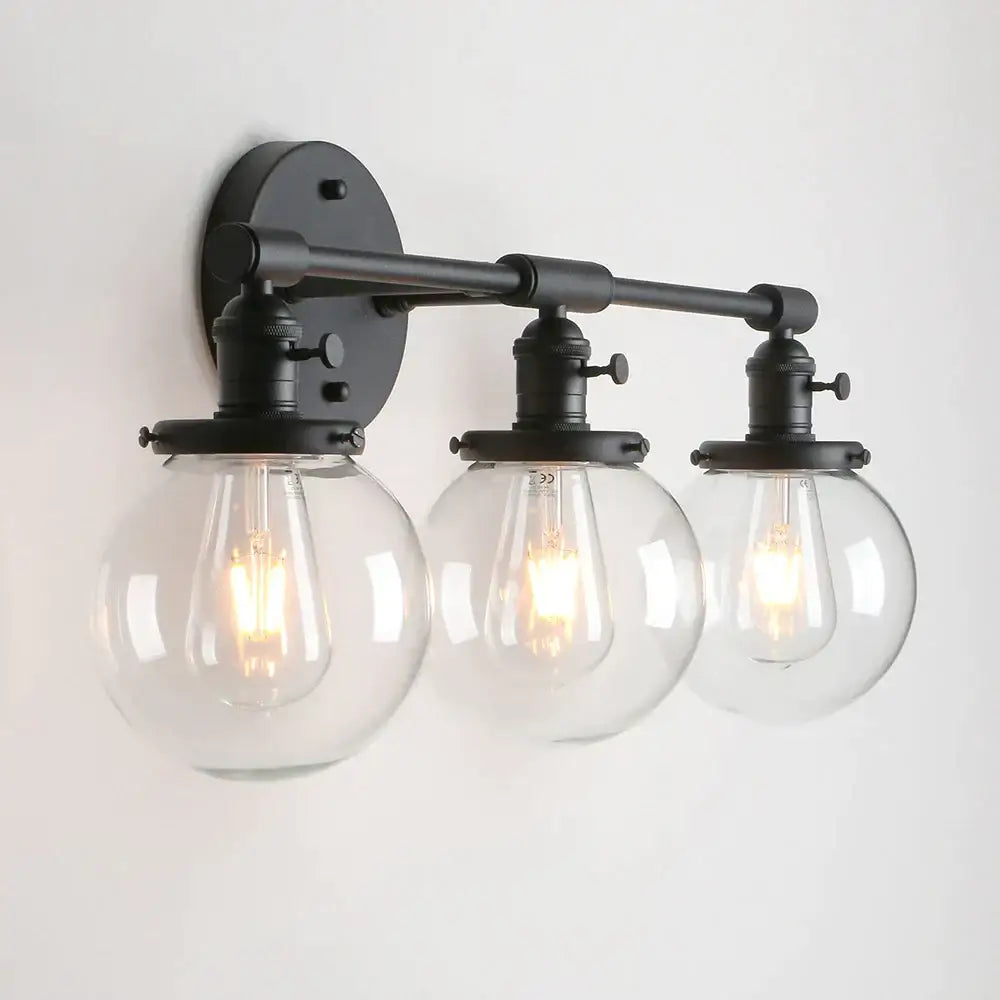 Modern black wrought iron wall sconce with three clear glass globe shades for sconce bathroom vanity lighting