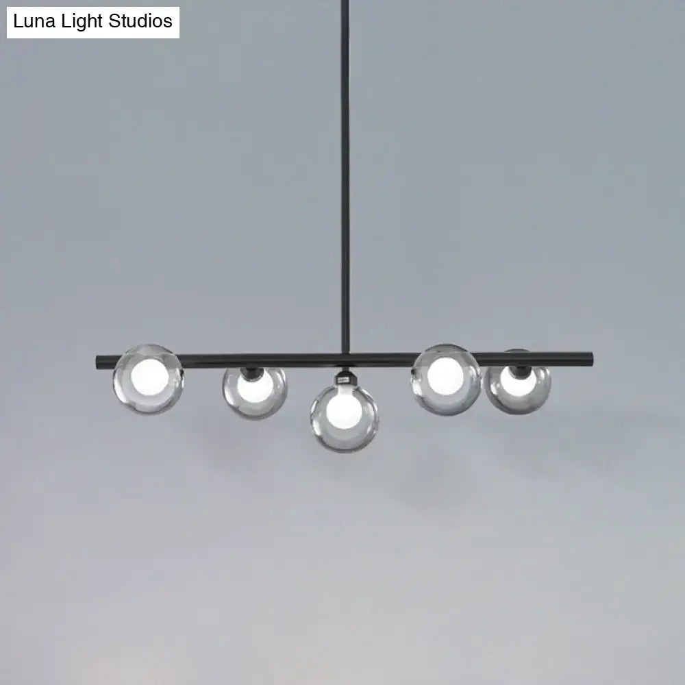 Modern black metal chandelier with five clear glass globe bulbs for dining room pendant lighting