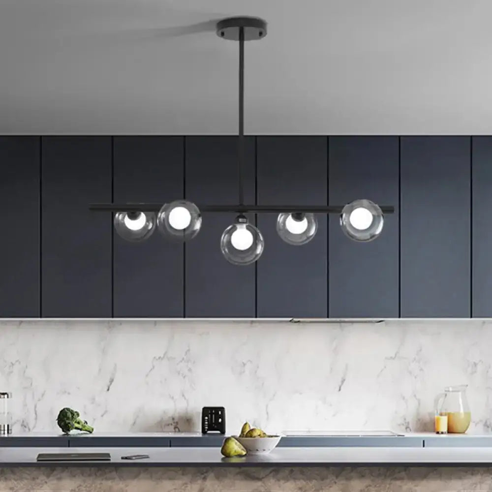 Modern black metal chandelier with five clear glass globe shades for dining room pendant lighting