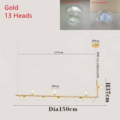 Gold-colored pendant light with 13 spherical glass shades on adjustable arm for modern dining room lighting