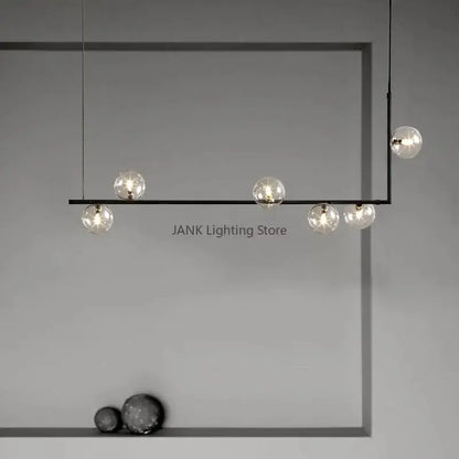 Modern black metal pendant light with five clear glass globe bulbs featuring double glass shade design for dining room