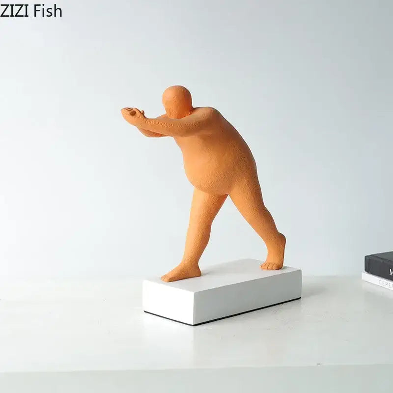 Orange resin figurine of a stylized bald humanoid in an athletic stance on a white base abstract resin sculpture for home decor
