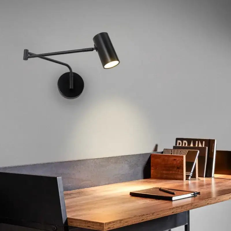 Modern black acrylic iron led wall lamp with matte finish and articulated arm for adjustable bedroom reading light decorbites