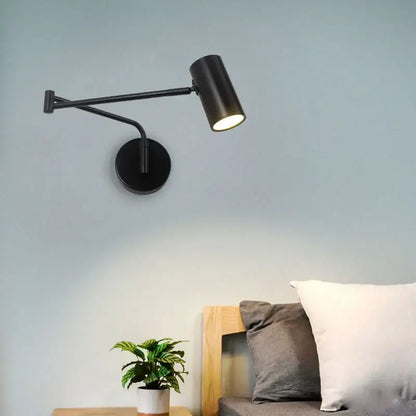 Modern black acrylic iron led wall lamp with matte finish, adjustable arm, and cylindrical head for bedroom reading