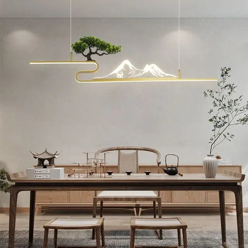 Gold-toned minimalist pendant lights with illuminated acrylic mountain peak and bonsai tree decorbites acrylic mountain design