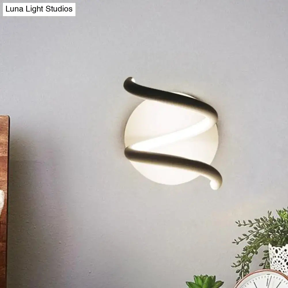 Modern black acrylic spiral sconce with a sleek curved metallic frame and frosted glass diffuser light fixture