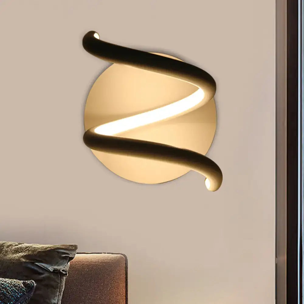 Modern black acrylic spiral sconce light fixture with sleek metal frame and warm glowing led for bedroom use