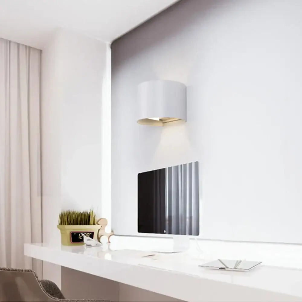 Modern black decorbites adjustable aluminum wall sconce with white cylindrical shade and gold-toned inner rim for bedroom lighting