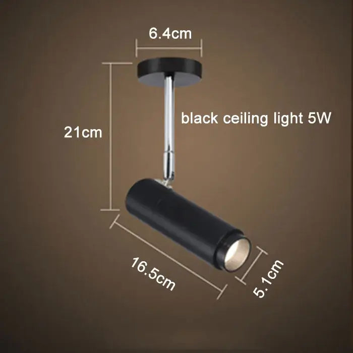 Modern black adjustable focus track lights with a sleek cylindrical head and chrome finished arm for commercial use