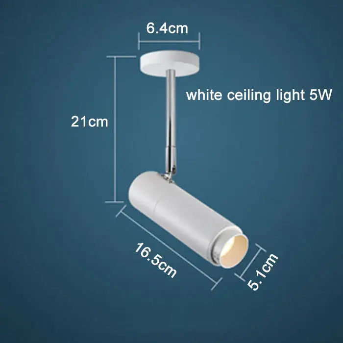 White ceiling-mounted adjustable focus track lights with sleek cylindrical design and chrome-finished mounting stem decorbites adjustable focus