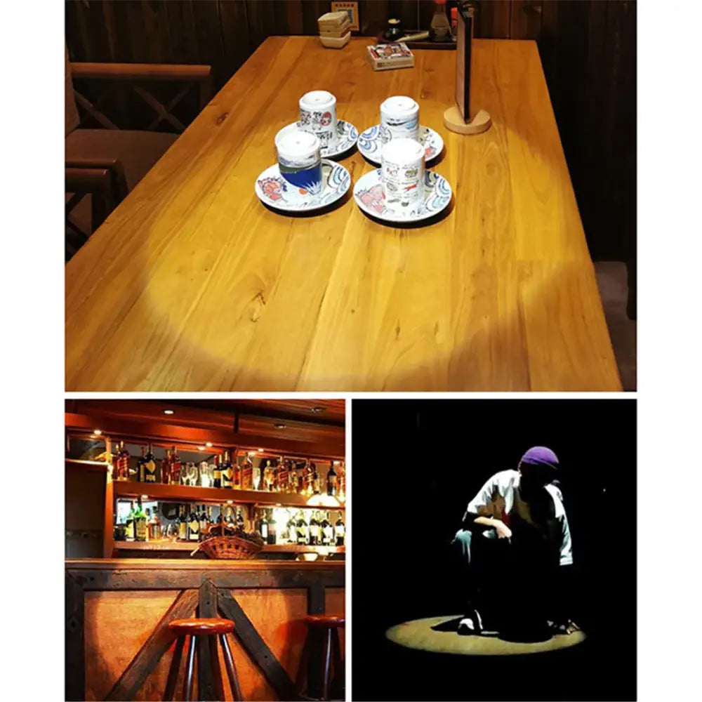 White ceramic teacups with blue floral patterns on matching saucers illuminated by modern black decorbites adjustable focus track lights