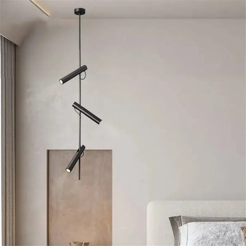 Modern black adjustable led spot bedroom pendant light with three cylindrical spotlight heads on a central rod decorbites black adjustable