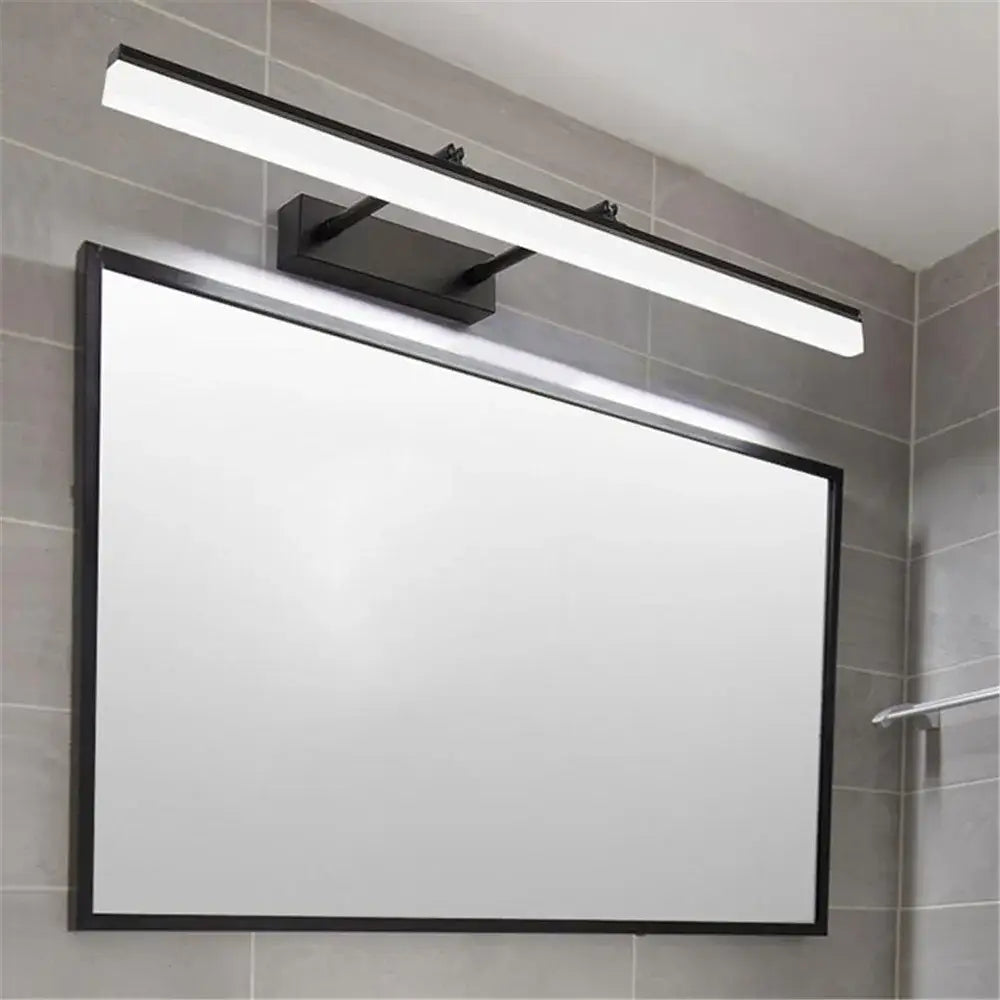 Modern black adjustable led vanity lights featuring a sleek rectangular design mounted above a white-framed mirror
