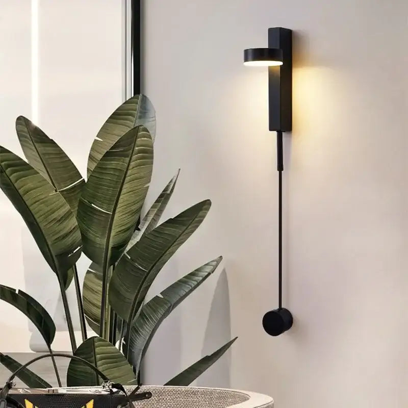 Modern black adjustable led wall lamp with sleek cylindrical design and warm focused lighting for bedroom decorbites lighting