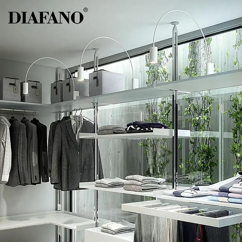 Modern black adjustable rocker wall lamp mounted above white metal shelving with curved arch lamps and gray storage boxes