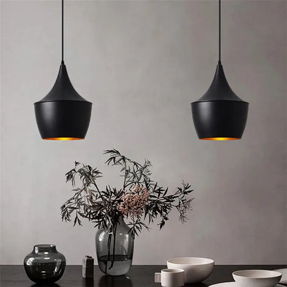 Two sleek black aluminium modern pendant lights with matte finish and warm golden glow for dining room decorbites decor
