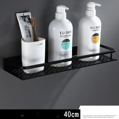 Modern black aluminum bathroom shelf with towel bar featuring a textured grid surface and three compartments for toiletries by decorbites
