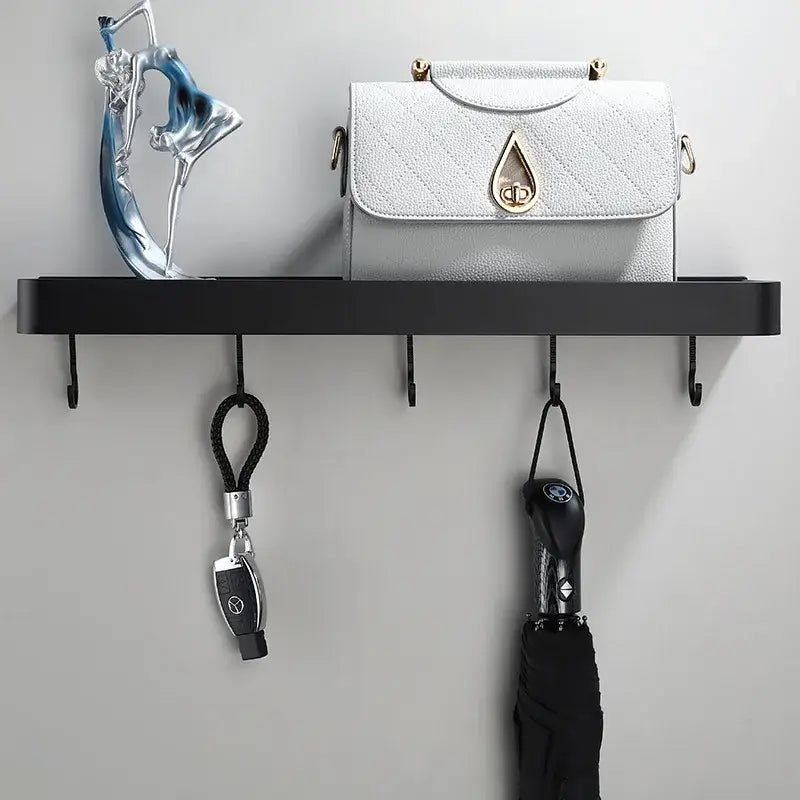 White quilted leather handbag with gold-tone teardrop clasp complementing decorbites black aluminum bathroom shower shelf with hooks and towel bar