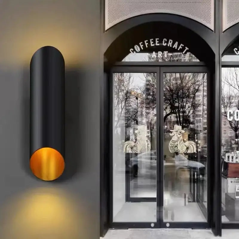 Modern black aluminum tube wall lamp with warm gold circular accent for bedroom decor from decorbites black aluminum