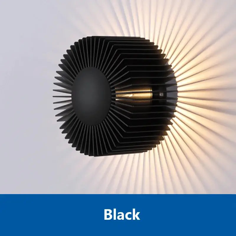 Modern black aluminum wall sconce with elegant radial fins and central brass accent for living room lighting