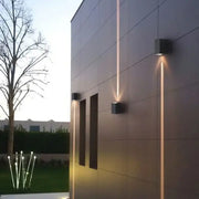 Modern black aluminum waterproof porch wall lamp with sleek square design casting warm vertical light beams