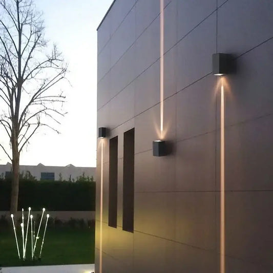Modern black aluminum waterproof porch wall lamp with sleek square design casting warm vertical light beams