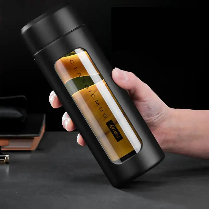 Modern black and amber insulated glass water bottle travel mug with transparent window and gold lettering