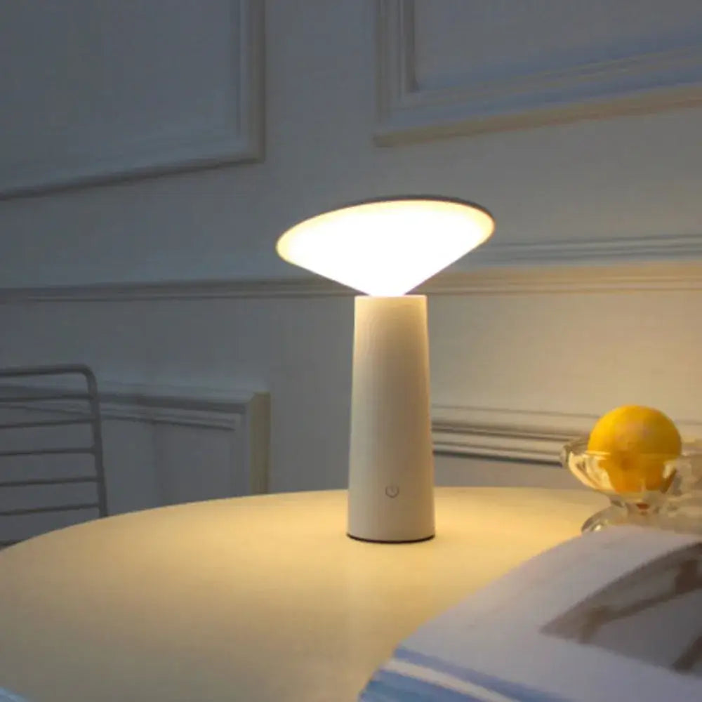 A sleek off-white cylindrical led usb desk lamp with touch sensor and minimalist design for bedroom use