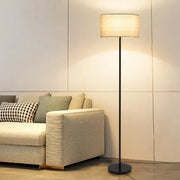 Modern black and beige led vertical floor lamp with cylindrical fabric shade for living room use