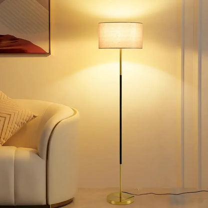 Modern black and beige led vertical floor lamp with gold finish and cylindrical fabric shade for living room use