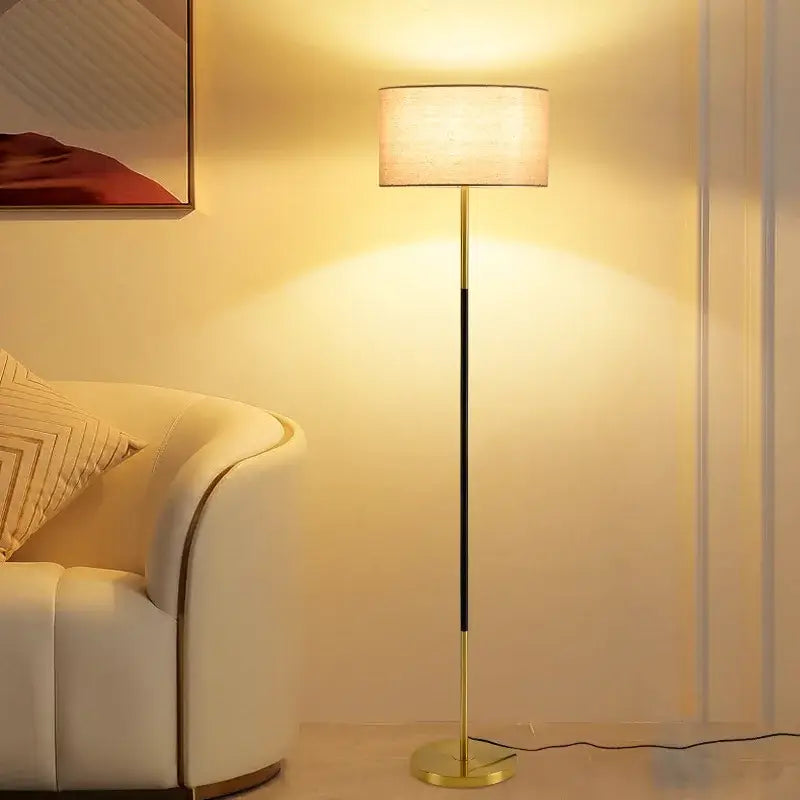Modern black and beige led vertical floor lamp with gold finish and cylindrical fabric shade for living room use