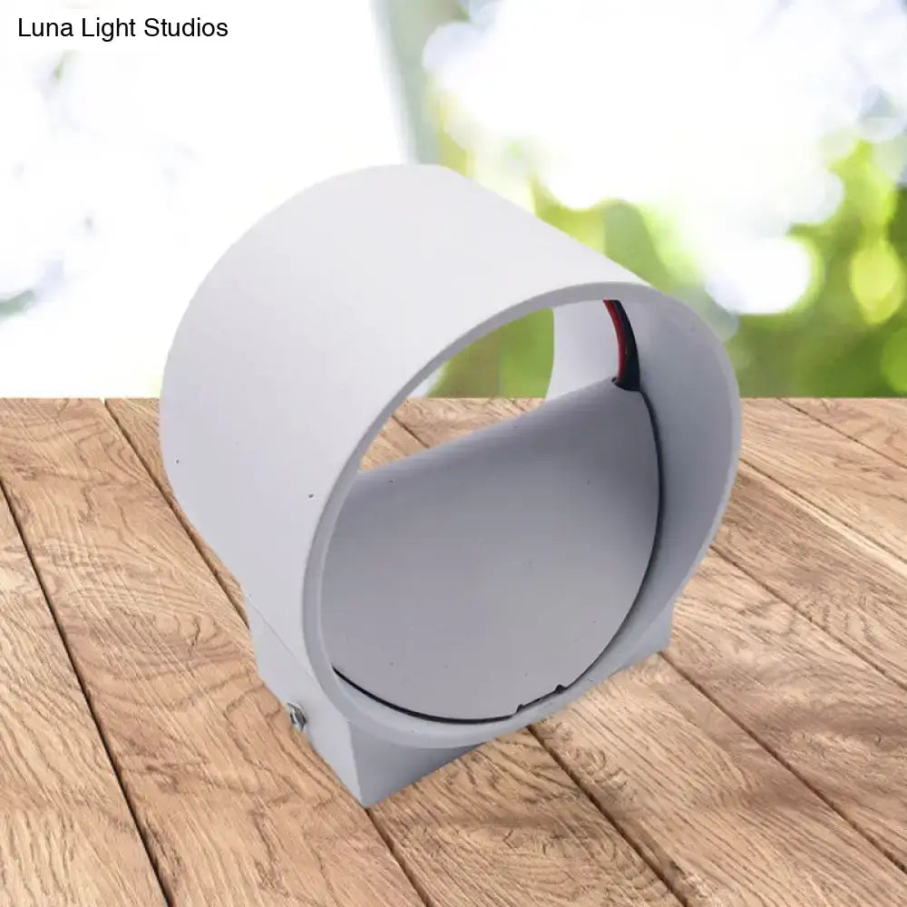 White cylindrical wall light with sleek modern design and matte finish in a modern black and blue velvet wall light kit