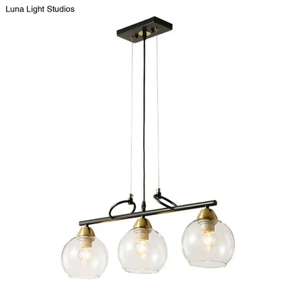 DecorBites™ black metal chandelier with three clear smoke gray glass globes and brass accents for hall island lighting