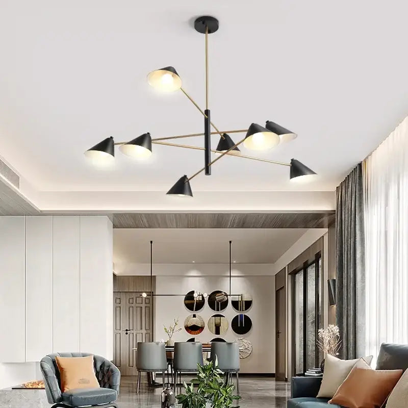Modern black and brass cone pendant light with gold-toned metal arms for dining room featuring decorbites cone pendant design