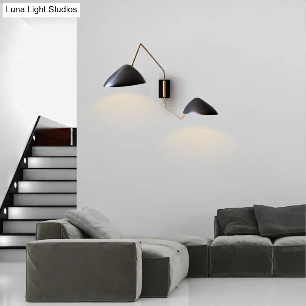 Modern black and brass metal duckbill reading wall light with conical sconce and articulated arms for bedroom use
